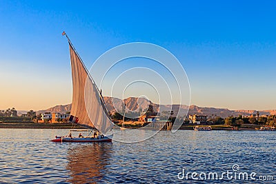 Felucca boats sailing on the Nile river in Luxor, Egypt. Traditional Egyptian sailing boats Editorial Stock Photo