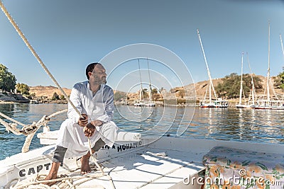 Feluccas captain Sailing his boat on the Nile near Aswan Egypt Editorial Stock Photo