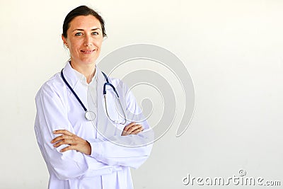 Femal doctor in white gown with stethoscope looking at camera in self-confidence manner Stock Photo