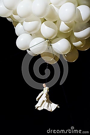 Female acrobat suspended from balloons Editorial Stock Photo