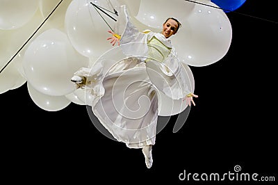 Female acrobat suspended from balloons Editorial Stock Photo