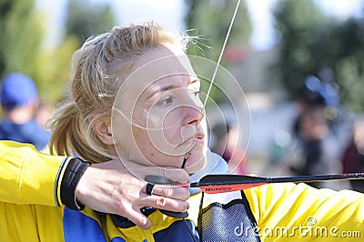 Female archer aiming at a mark on an archery shooting range Editorial Stock Photo