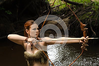 Female archer shoots a bow Stock Photo