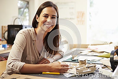 Female Architect Making Model In Office Stock Photo