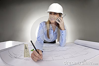 Female architect working on blue prints Stock Photo