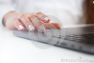 Female arms in typing using laptop pc at office Stock Photo