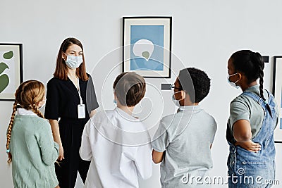 Female Art Expert Talking to Kids in Gallery Stock Photo
