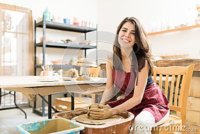 Female Artist Making Clay Pot On Pottery Wheel Stock Photo