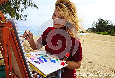 Female artist painting outdoors Stock Photo