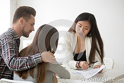 Spouses visiting real estate agent to buy house together Stock Photo