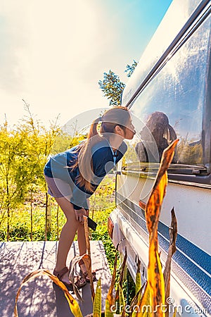 Female asian standing beside the trailer home in Camping ground area Stock Photo