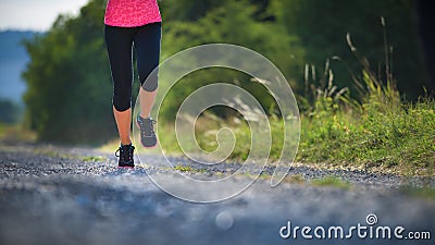 Female athlete runner. closeup on shoe. woman fitness sunset jog Stock Photo