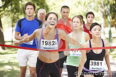 Female Athlete Winning Marathon Race Stock Photo