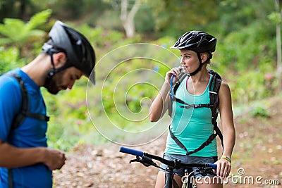 Female athletic drinking water from hydration pack Stock Photo