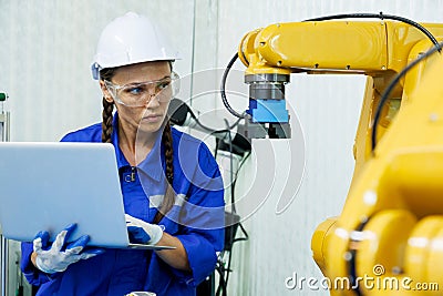 female automation machine engineer student study and inspection control robot arm machine in university or factory workshop. ai Stock Photo