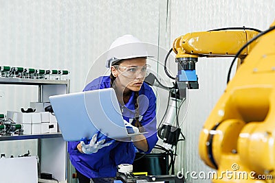 female automation machine engineer student study and inspection control robot arm machine in university or factory workshop. ai Stock Photo