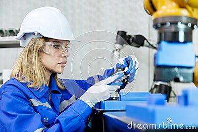 female automation machine engineer student study and inspection control robot arm machine in university or factory workshop. ai Stock Photo