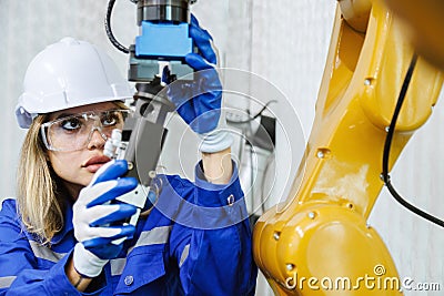 female automation machine engineer student study and inspection control robot arm machine in university or factory workshop. ai Stock Photo