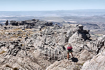 Female backpacker looks at mountain landscape Stock Photo