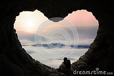 Female backpacker sitting in cave Stock Photo