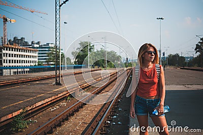 Female backpacker waiting for the train Stock Photo