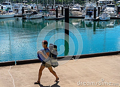 Female Backpacker Walking Beside A Marina Editorial Stock Photo