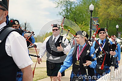 Female bagpiper in pipe and drum corps Editorial Stock Photo