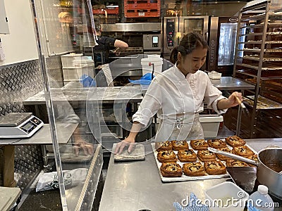 Female Baker Preparing Baked Goods and Pastry in South Melbourne Market Photo Editorial Stock Photo