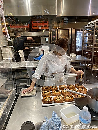 Female Baker Preparing Baked Goods and Pastry in South Melbourne Market Photo Editorial Stock Photo