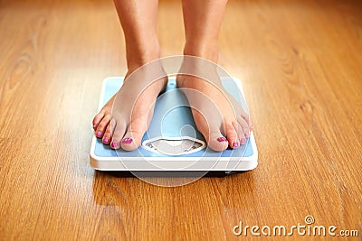 Female bare feet with weight scale Stock Photo