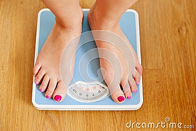 Female bare feet with weight scale Stock Photo