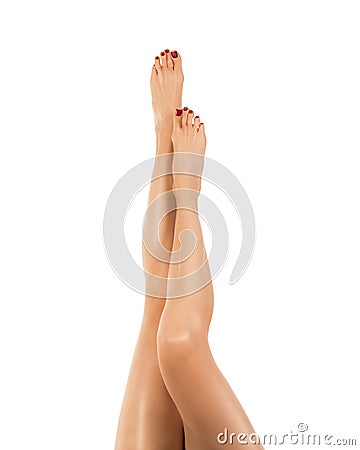 Female barefoot legs with classic red pedicure, woman raise her feet up, tanned skin tone. isolated on white. Stock Photo