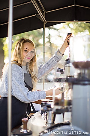 Female barrista making coffee for clients Stock Photo