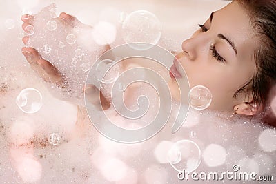 Female in bath with foam Stock Photo