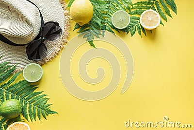 Female beach straw sunhat, sunglasses, citrics on yellow. Top view. Summer travel concept Stock Photo