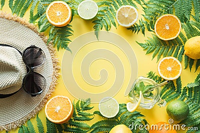 Female beach straw sunhat, sunglasses, citrics on yellow. Top view. Summer travel concept Stock Photo