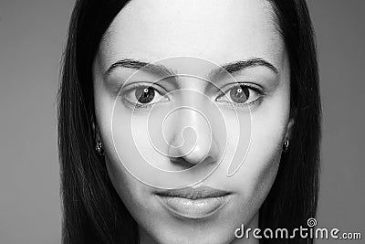 Female beauty concept. Portrait of a smiling beautiful brunette girl with alien-like face posing over gray background. Healthy Stock Photo