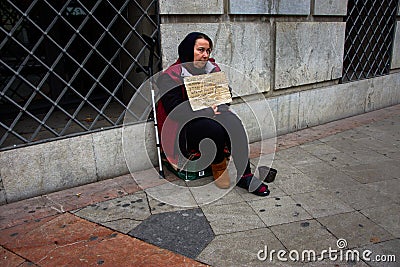 Urban scene: a female beggar in Granada 34 Editorial Stock Photo