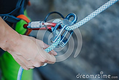 Female belayer with the rope and carabines. Stock Photo