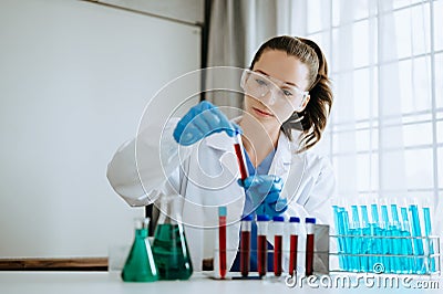 Female biotechnologist testing new chemical substances in laboratory Stock Photo