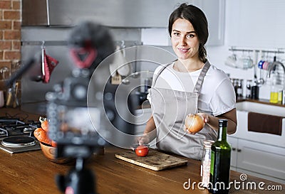 Female blogger recording cooking related broadcast at home Stock Photo