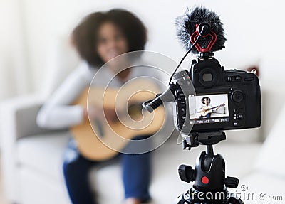 Female blogger recording music related broadcast at home Stock Photo