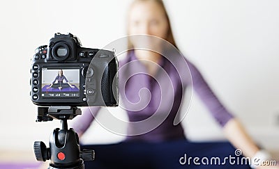 Female blogger recording sports related broadcast at home Stock Photo