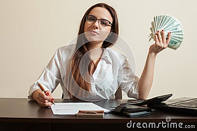Female bookkeeper holding dollars fan in her hand Stock Photo