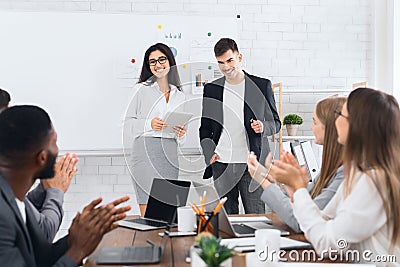 CEO woman introducing new hire employee to office workers Stock Photo