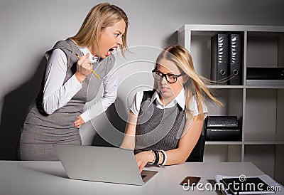 Female boss about to kill her employee with pencil Stock Photo