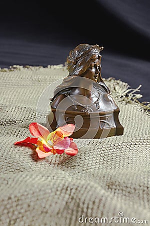 Female Bronze Bust and Flower Stock Photo