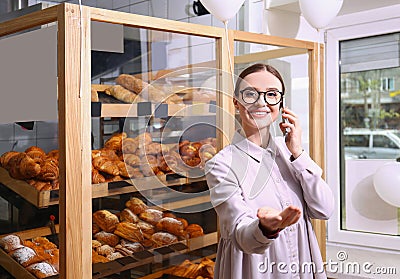 Female business owner talking on mobile phone Stock Photo