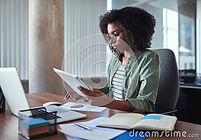 Female businesswoman analyzing the business report in the office Stock Photo