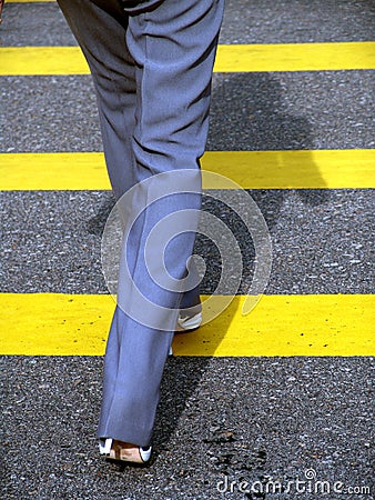Female businesswoman crossing road Stock Photo